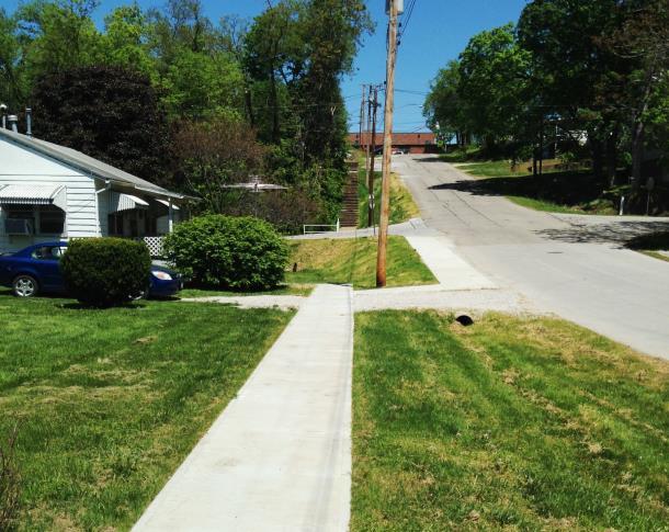 Beginning about 200 feet southwest of Jefferson Street and extending to Koskiusko Street, Van Buren has variable width, turf shoulders and open ditches with sidewalks at the back of the ditches.