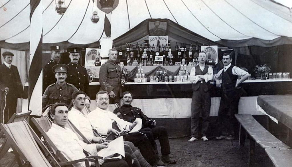 This postcard shows a Sergeant s mess that is well stocked with Allsopp s beer at the annual camp of 1912. Standing at the bar is 2 Regimental Quartermaster Sergeant Harry Petrie.