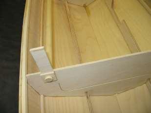 Slip the dowel into the holes on the bulkheads. Note that the pictures show a different boat.