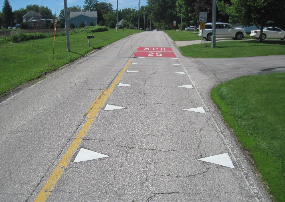 26), or any other type of marking covered in the MUTCD. The markings are white for both sides in compliance with Section 3B.15 in the MUTCD, which states that transverse markings should be white.