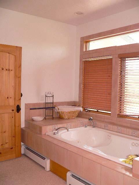 It features a two-person whirlpool tub, double sinks and a
