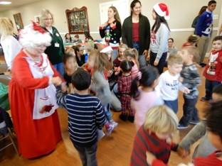 The Children s Christmas Party saw Peg Malley (at right) instructing the volunteer teens on what to do