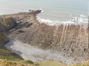 The slumped (collapsed) cliff material is carried away over time by Long shore drift and the cliff retreats (moves backwards) Hint: remember to use key terms when describing the formation of these