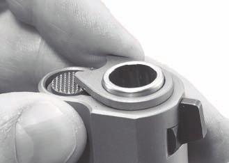 Use the barrel bushing wrench or your fingers and turn the bushing counterclockwise (see Figure 28) until the recoil spring plug locks into place. (See Figure 29.