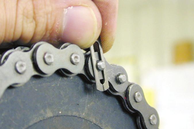 B. Install the master link by running the part with the pins into the ends of the chain, as shown in figure 55. Figure 55.