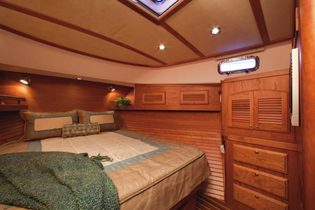 Luxurious cherry hull ceilings finish off the hull sides and convenient shelves and lockers are located above the berth.