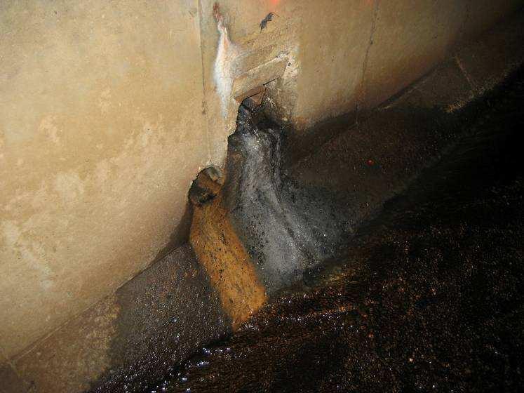 Photo 3: Suspected Illicit Discharge, Entering Culvert From the East, At Centerline± of Main Street Photo 4: Dark Black Color of Discharge from 4 Iron Pipe The Milford Sewer Department (MSD) was