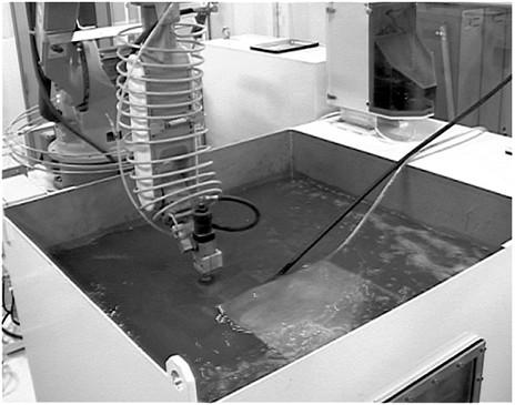 Figure 1 Water tank and robot arm for submerged cutting tests Figure 2 Sheathed ASJ nozzle (sheath length: 16 mm) In order to clarify the flow aspects of an air-coated jet under submerged conditions,