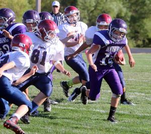 Louisburg seventh-grade quarterback Dawson Barnes finds some running room Tuesday at Wildcat Stadium. The Wildcats drove the ball down the field and it ended with a 2-yard touchdown run from Johnson.