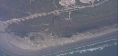 Figure 23 is an aerial photo taken two days after Hurricane Rita. It shows sand waves oriented to the southwest (toward the pass). Figure 24 is a ground photograph of these features.