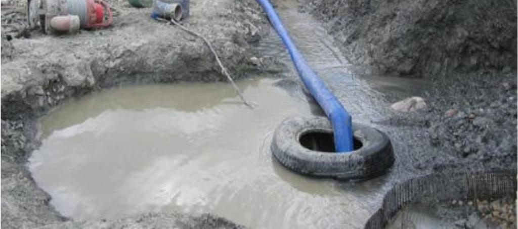 Surface pumps with hoses are used to pump water from the