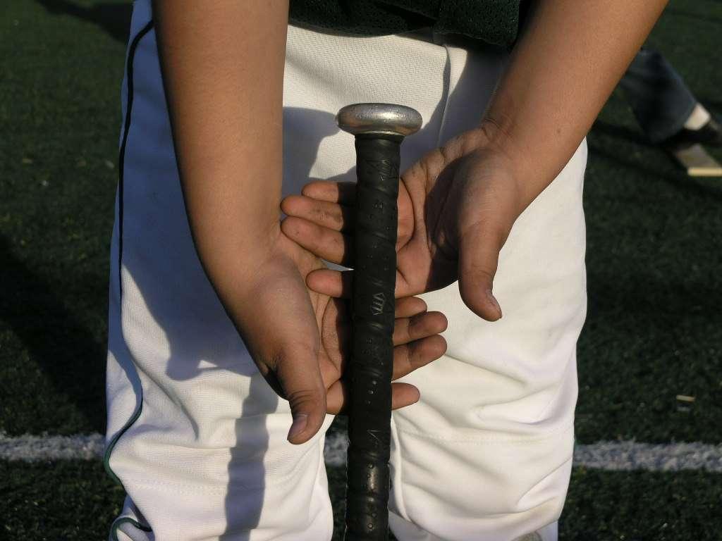 BATTING Proper Grip: Rest the bat in the fingers (the groove at the bottom of the fingers of both hands) not in