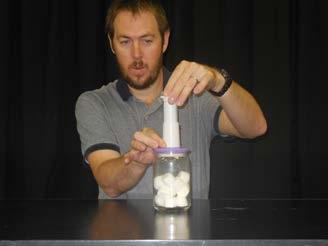 When the pressure in the container decreases, the gas particles in the marshmallows will begin to spread and the volume will get bigger.