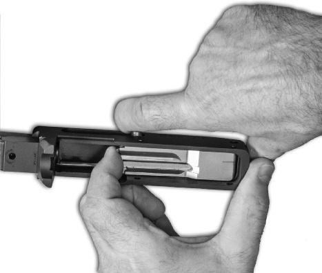 Pull the bolt handle fully to the rear of the receiver with one hand, and while it is held fully to the rear, lift up the front of the bolt until it is disengaged