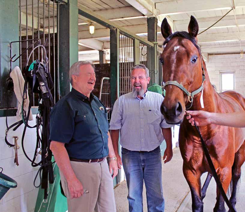 Executive Producer BUSINESS IS GOOD: Thomson shares a laugh with Winbak Farm Yearling Manager Jim Ladwig (center) and General Manager Garrett Bell (right). Brown Jug Wall of Fame in 2009.