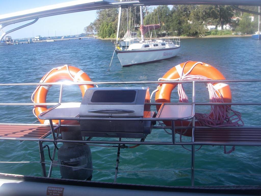 Life rings Life rings are located each side of the BBQ on the rear seats If someone falls over board Keep an eye on them and throw them a life ring Notify the skipper Take a bearing on the compass