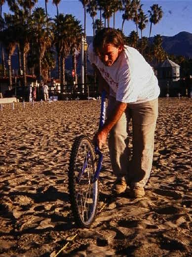 from the middle back to the ends, alternating on each line) or by rolling a bicycle wheel with the air let out of the tire, over the rope to press the rope into the sand.