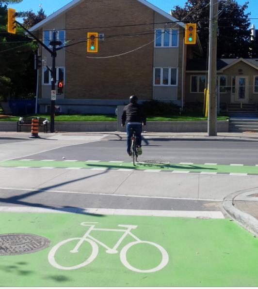 When signal is green, proceed to the bike box on the side street. 2.