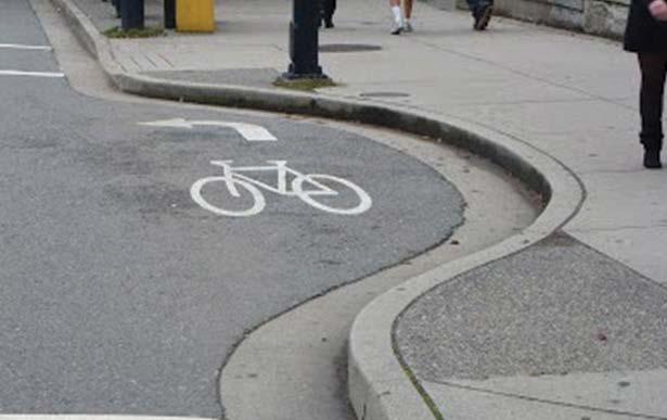 Jug Handles At T-intersections, jug handles allow cyclists to reorient their bike before crossing the road.