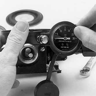 Insert the assembly and screw the cap into the regulator body and hand-tighten. d. Close the main-line valve.