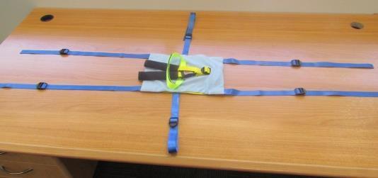 Two extra yellow straps FITTING THE BABY HARNESS RESTRAINT Lay out the baby harness as shown Open the lid of the cot Pick up the harness