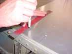 Use a straight edge along the pre-drilled holes to extend the line to the edge