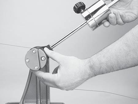 The tension in the string provides the clamping force to the jaws.