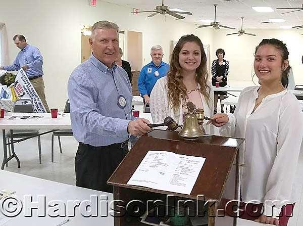 Ceremoniously ringing the bell to close the meeting are (from left) Gilchrist County Rotary Club President Bob Clemons, THS Interact Club President Alexis Haynes and BHS Interact Club President