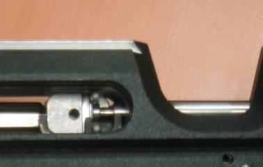 After the screw (f) has been loosened (approx. 3 rotations counterclockwise), the pivot pin (g) can pulled out of the hole with the attached parts and re-inserted on the opposite side.