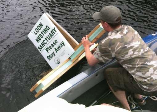Ray Lewis floats a Loon Nesting Sign.
