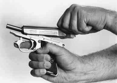 (Figure 13) When the front FIGURE 15 of the trigger guard comes out of the frame, press it sideways with your index finger to keep it from springing back up into the frame.