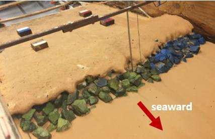 11 COASTAL ENGINEERING 2016 Figure 12: Exposed stone due to dune erosion after test BL where 4 wooden blocks were placed on berm STONE DAMAGE Damage progression of the stone seawall is analyzed for