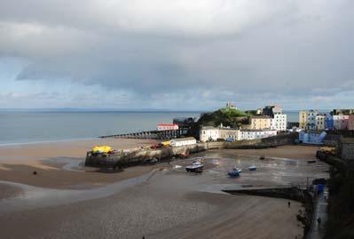 Beach with harbour Tenby- sailing dinghy activity off