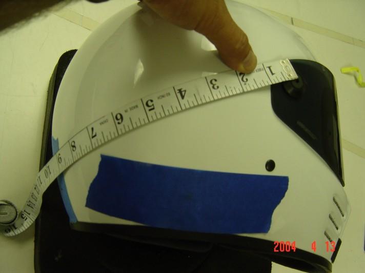 To locate the D-rings: Find the center of the helmet by: 1) Place a piece of masking tape at the center of the rear