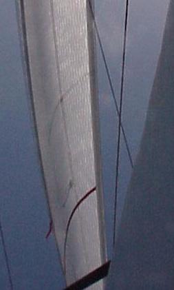 Pulling the jib downhaul tight will remove wrinkles and also pull the draft of the sail forward.