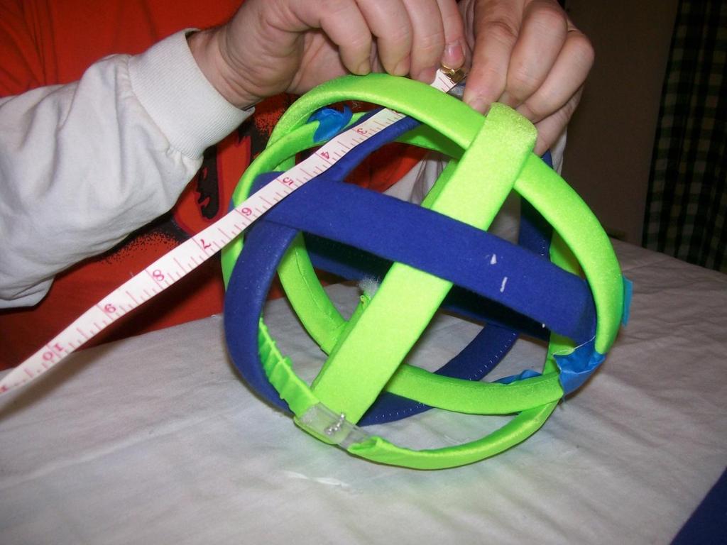 Using the real Orbit Ball as a guide, continue to add each remaining skeleton strip to the first assembled strip repeating the circumference measuring, clamping, drilling, and pop