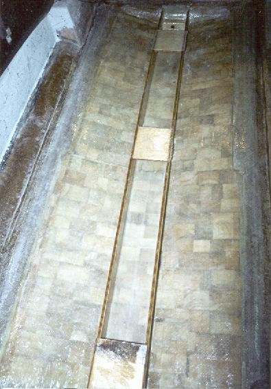 Note that the bilge drain tube has been epoxied in place. Also visible is some of the preparation work required for the new floor.