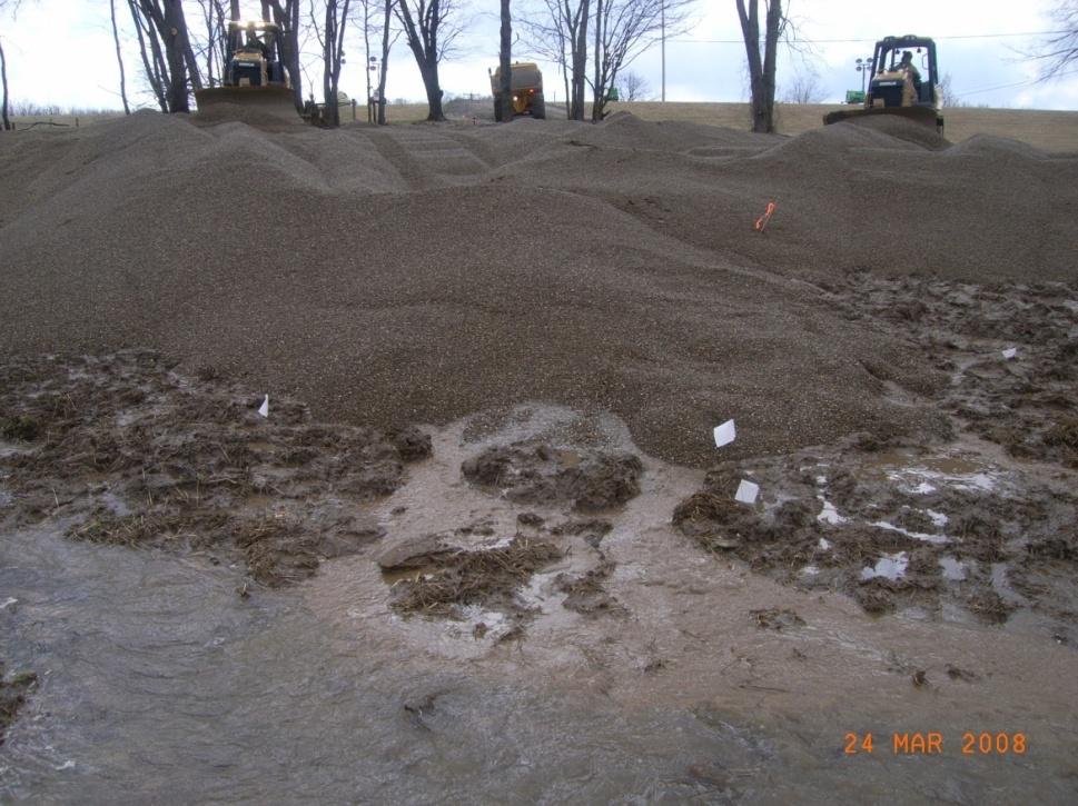 This is called a seepage blanket in that it tries to block any soil moving from the boils while distributing the water.