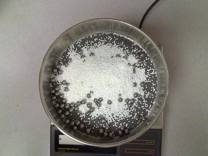 Turn on the ro-tap testing sieve shaker for 15 minutes. Measure the total mass of the pan and fractured prills collected.