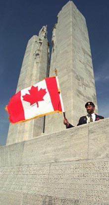 An unidentified Canadian officer waves his national flag at the Vimy memorial during ceremonies commemorating the 80th anniversary of the Vimy Ridge battle, northern France, Wednesday April 9, 1997.