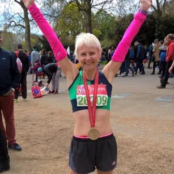 Sian models the new Driffield Striders pink arm stretchers at the London Marathon Fantastic performances at the