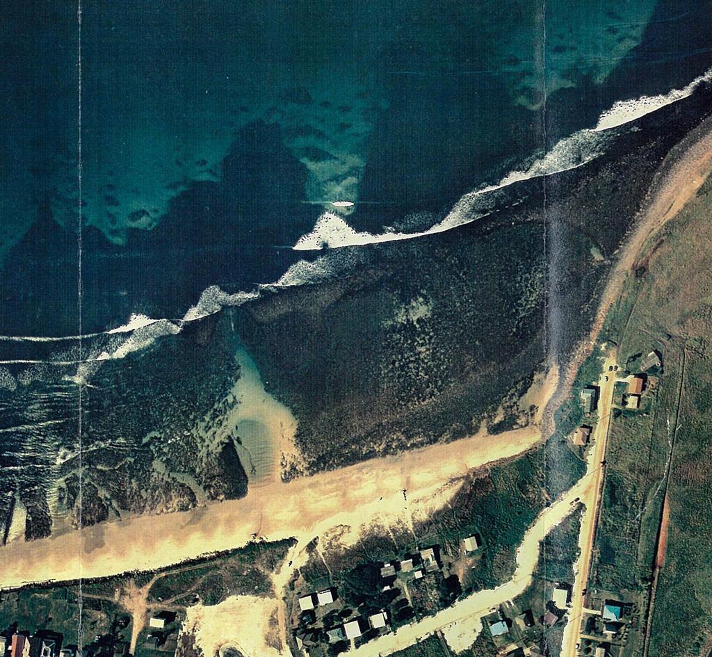 Reef representation in model Lennox Head reef (1977) Figure 7 Sloping reef representation Further, the coastline south of the river faces southeast and the longshore transport regime is critically