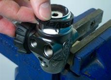 With the Valve Body held so that the inlet connection port points down,
