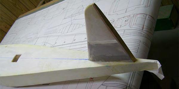 The hull is covered with paper. You can use the paper that was removed from the foam boards or brown packing paper.