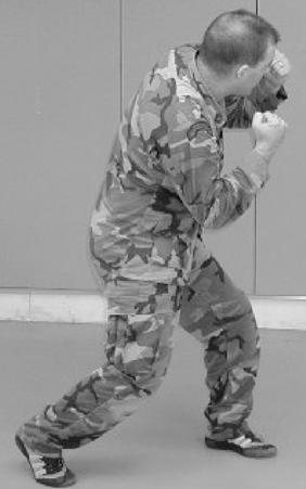 Figure 6-5. Lead hand uppercut, step 2. (c) Step 3. Turn your shoulders and snap back into the ready position. (2) Trail Hand Uppercut.