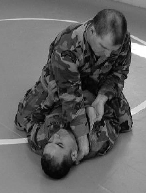 (2) Step 2 (Figure 3-39). While keeping a hold with the weak hand, the fighter now inserts his strong hand, fingers first, onto the collar.