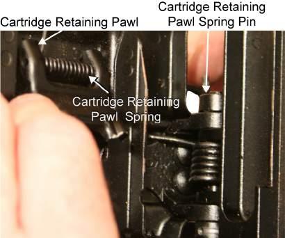 TM 8370-50107-IN/18 0014 00 10. Use needle nose pliers to lift the hooked end of the cartridge retaining pawl retaining pin out of the hole in the feed tray cover and turn it to either side.