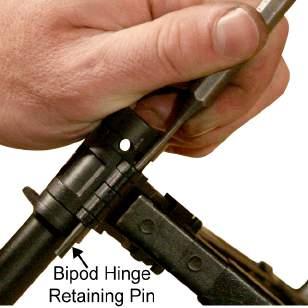 TM 8370-50107-IN/18 0017 00 1. Using a punch, tap out one of the bipod hinge retaining pins from the bipod assembly. Refer to Figure 1. Figure 1. Driving Out the Bipod Hinge Retaining Pin. 2.