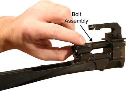 While turning the bolt assembly, engage the bolt cam into the cam recess of the bolt carrier by pulling the bolt assembly forward in the bolt