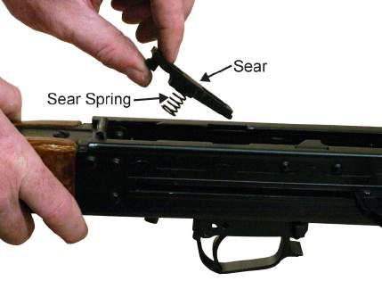 of the receiver. Refer to Figure 14. Figure 14. Depressing the Sear and Removing the Trigger Retaining Pin. 15.